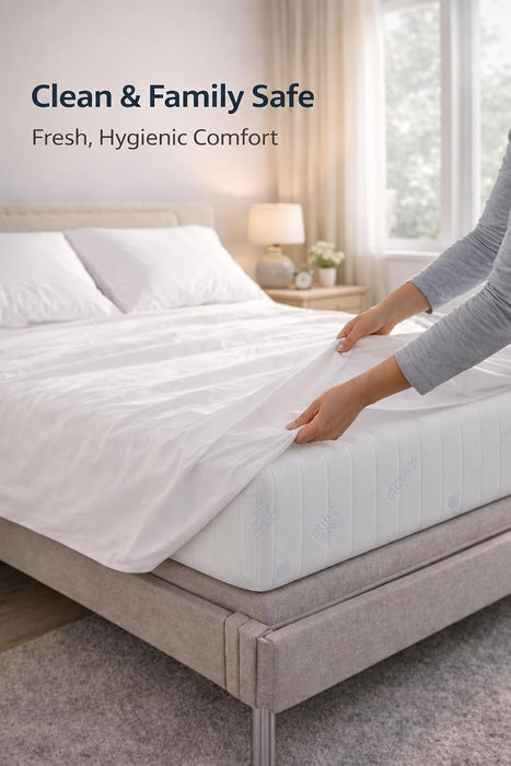 Hands fitting a white sheet over the Visco Therapy mattress on a bed base