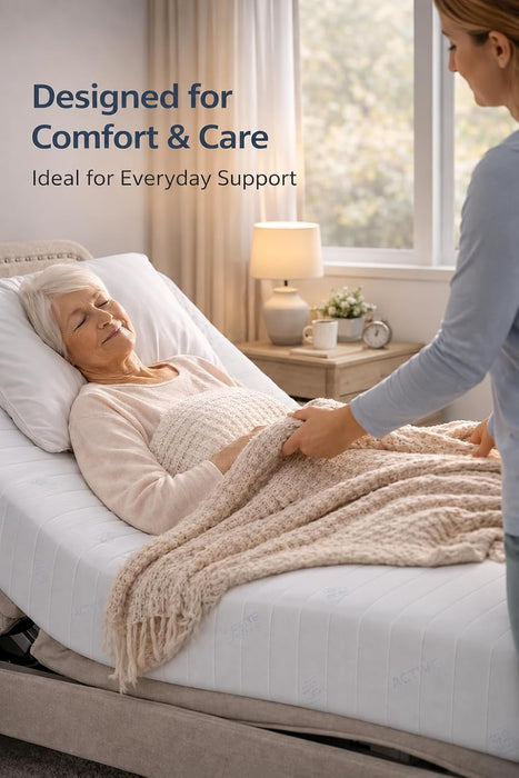Carer tucking a blanket over an older woman resting on a Visco Therapy mattress on an adjustable bed