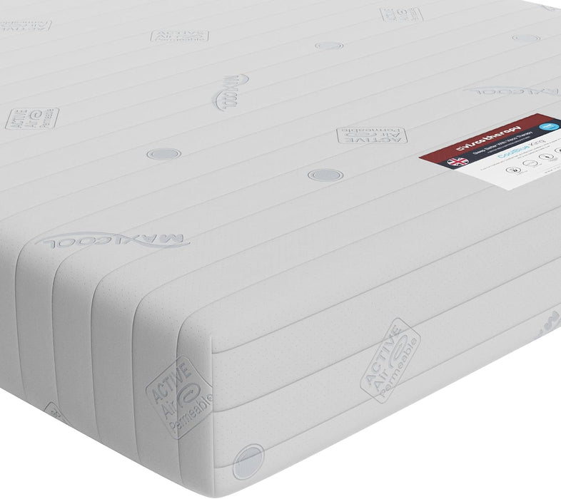 Close-up corner of the Visco Therapy adjustable bed mattress showing the white knitted cover and care label